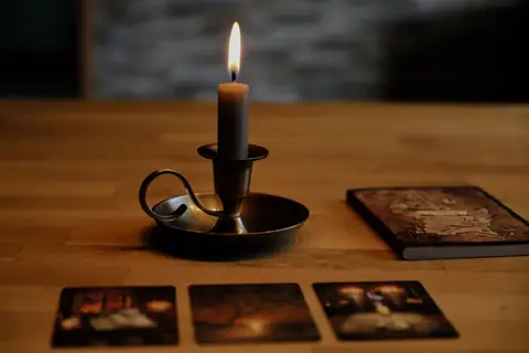 Candle and cards on a table