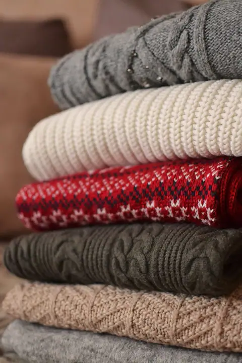 Stack of folded knit sweaters