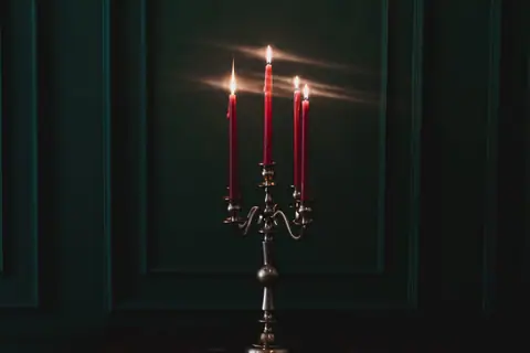 Red tapers in a silver candelabra